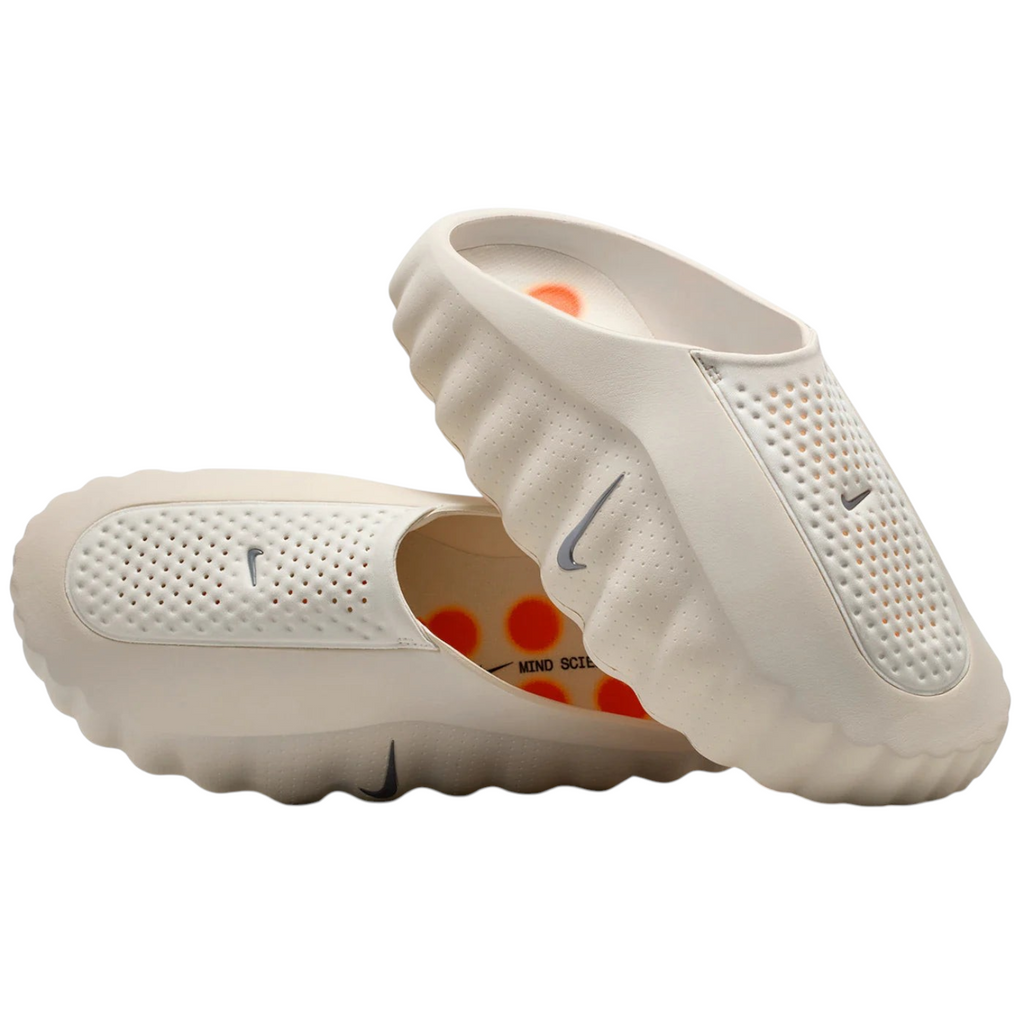 JeevzPlug Nike Mind 001 Slide in Light Bone featuring a sculpted one-piece upper, perforated details, and orange accents.