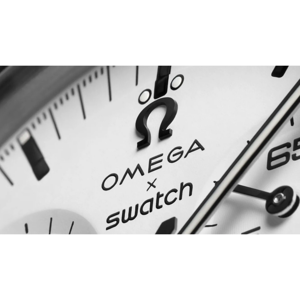 JeevzPlug Swatch x Omega Moonswatch 1965 white dial detail with iconic branding and black chronograph hands