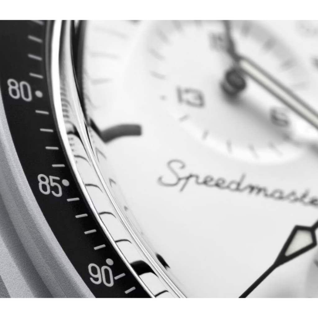 JeevzPlug Swatch x Omega Moonswatch 1965 bioceramic watch with white dial and black tachymeter bezel detail