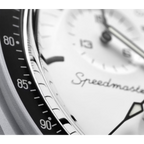 JeevzPlug Swatch x Omega Moonswatch 1965 bioceramic watch with white dial and black tachymeter bezel detail