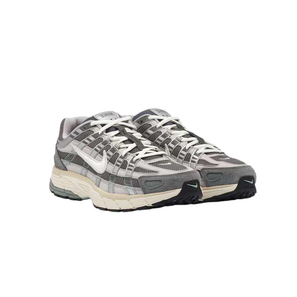 JeevzPlug Nike P-6000 Flat Pewter sneakers featuring grey mesh, metallic silver leather overlays, and suede accents.
