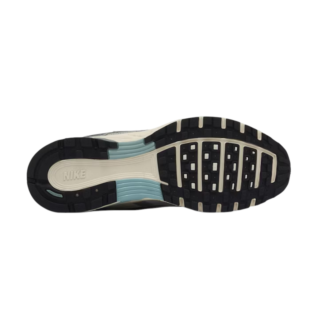 JeevzPlug Nike P-6000 Flat Pewter sneaker showing the durable black and cream rubber outsole with blue arch support