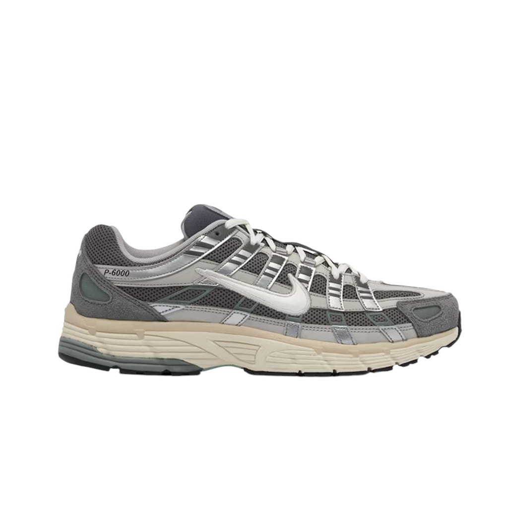 JeevzPlug Nike P-6000 Flat Pewter sneaker with grey mesh, metallic silver leather overlays, and suede accents.