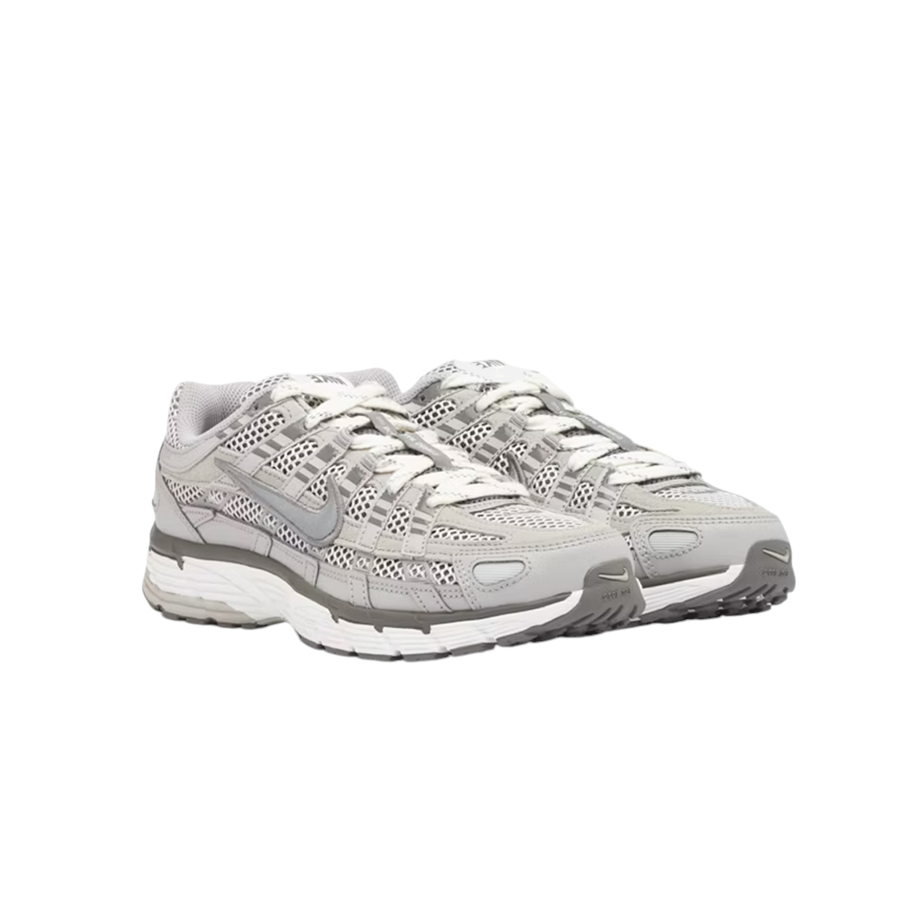 JeevzPlug Nike P-6000 Light Iron Ore sneakers featuring mesh and leather overlays with metallic silver Swoosh details.