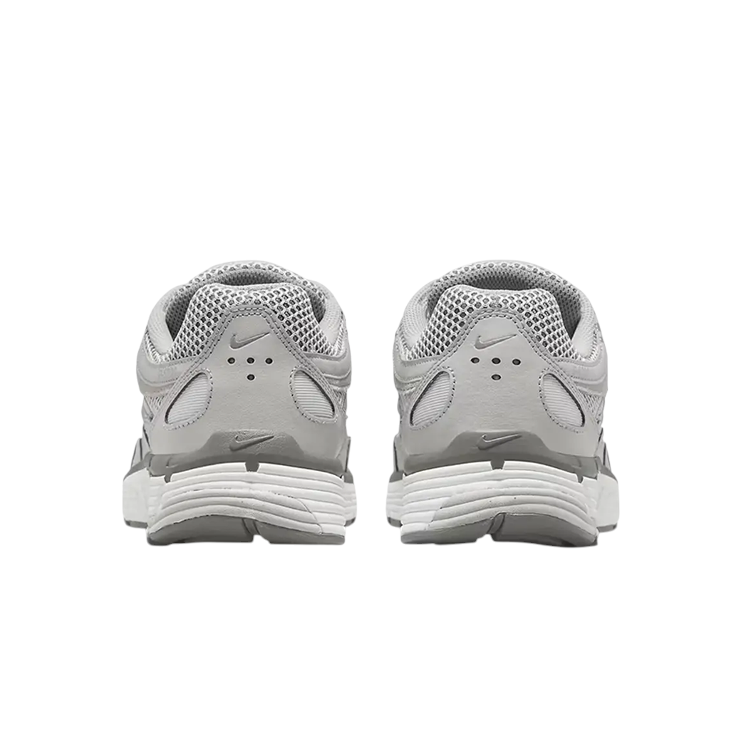 Rear view of JeevzPlug Nike P-6000 Light Iron Ore sneakers showing grey mesh, leather overlays, and white midsoles.
