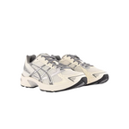 JeevzPlug ASICS Gel-1130 women's sneakers in cream and clay grey with mesh upper and synthetic leather overlays.