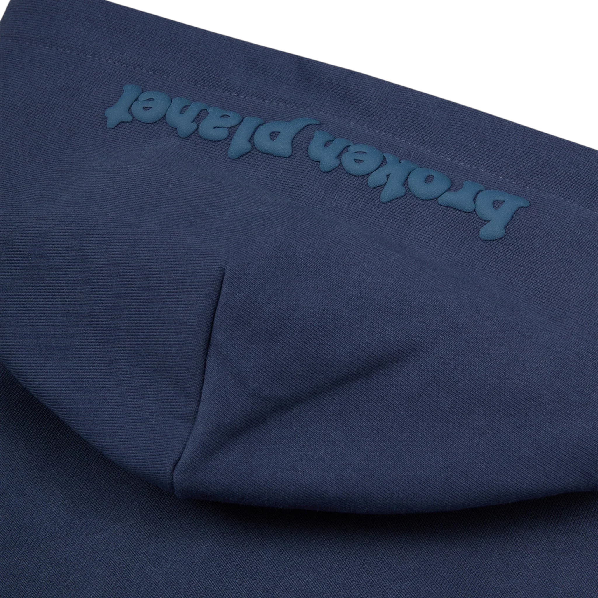 JeevzPlug Broken Planet deep navy zip-up hoodie featuring embossed logo detail on the hood in heavyweight cotton