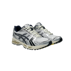 JeevzPlug JJJJound x ASICS Gel-Kayano 14 sneaker in white and midnight navy with metallic silver mesh detailing.