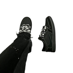 JeevzPlug Nike Air Jordan 1 Low Travis Scott Black Phantom sneakers on foot with black patterned laces and white stitch