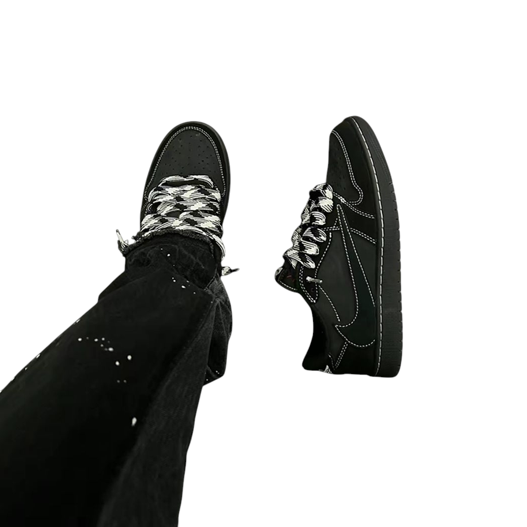 JeevzPlug Nike Air Jordan 1 Low Travis Scott Black Phantom sneakers on foot with black patterned laces and white stitch