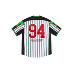 Back view of JeevzPlug Supreme white baseball jersey with green pinstripes, red number 94, and green star accents.
