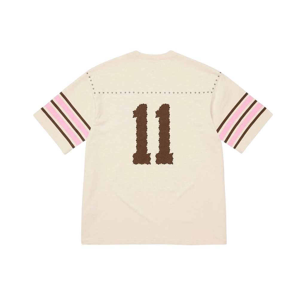 JeevzPlug Supreme cream short sleeve football jersey with studded shoulder detail and brown number 11 on the back.