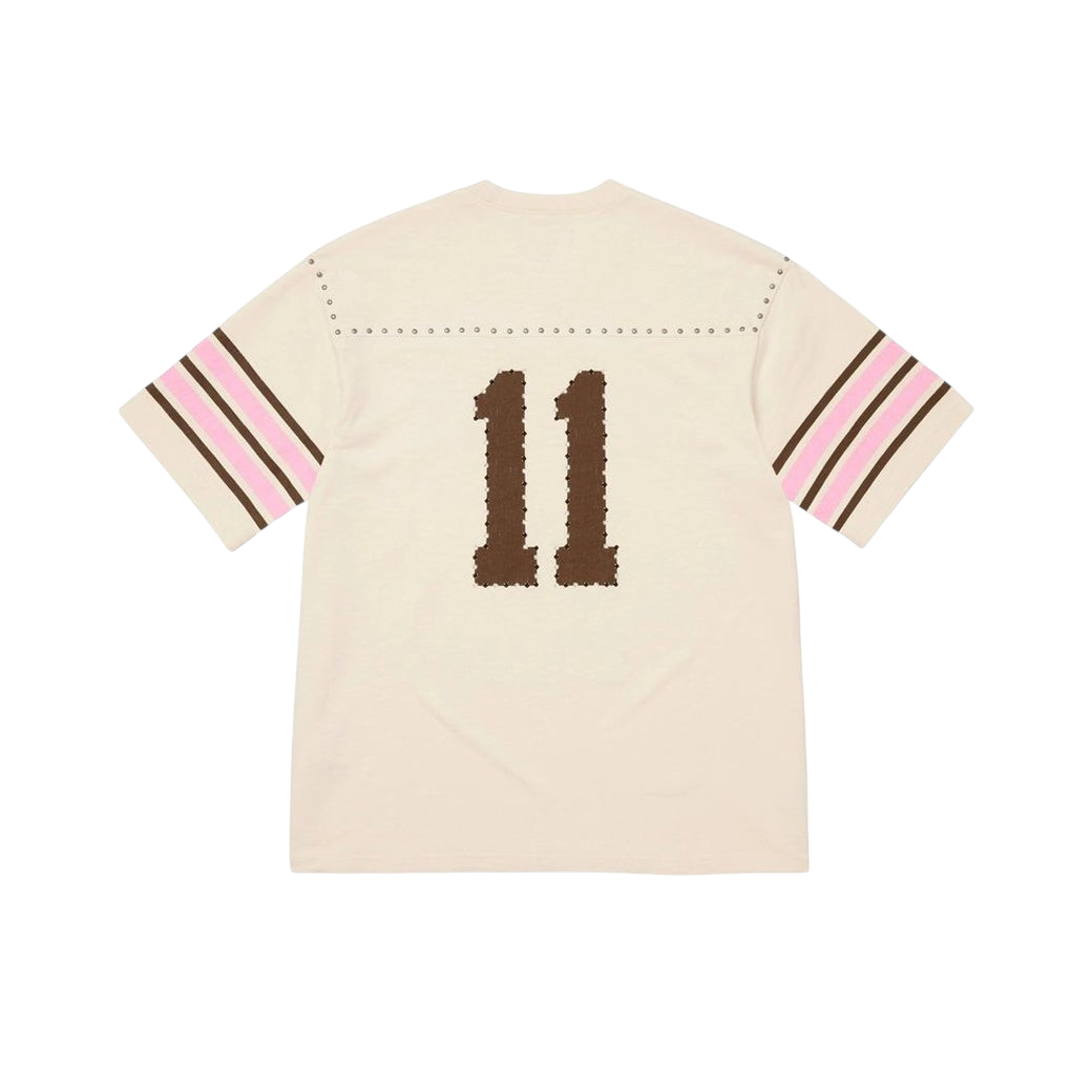 JeevzPlug Supreme cream short sleeve football jersey with studded shoulder detail and brown number 11 on the back.