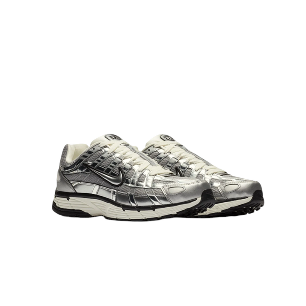 JeevzPlug Nike P-6000 Metallic Silver sneaker with chrome synthetic leather overlays and black Swoosh detailing.