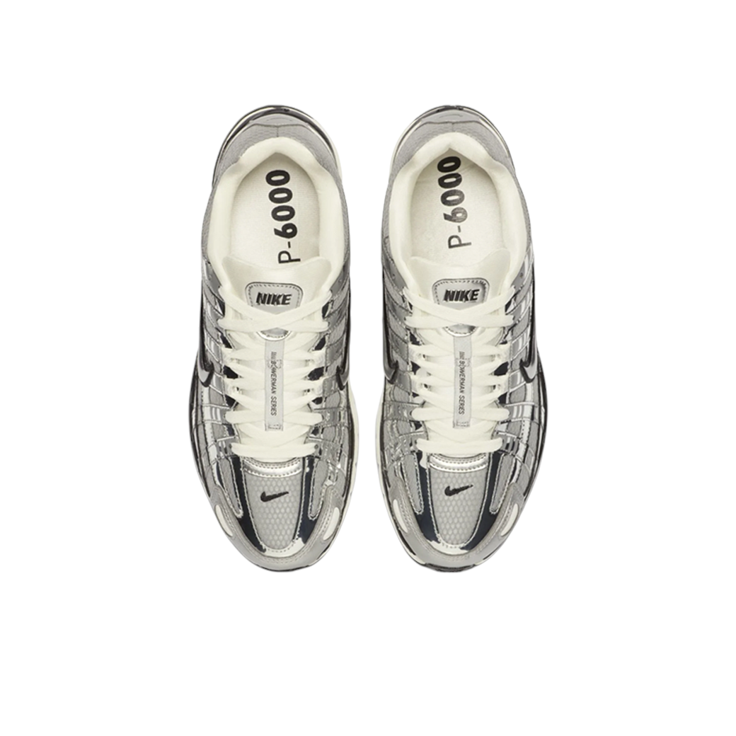 JeevzPlug Nike P-6000 Metallic Silver sneakers featuring chrome synthetic leather overlays and white laces, top view.