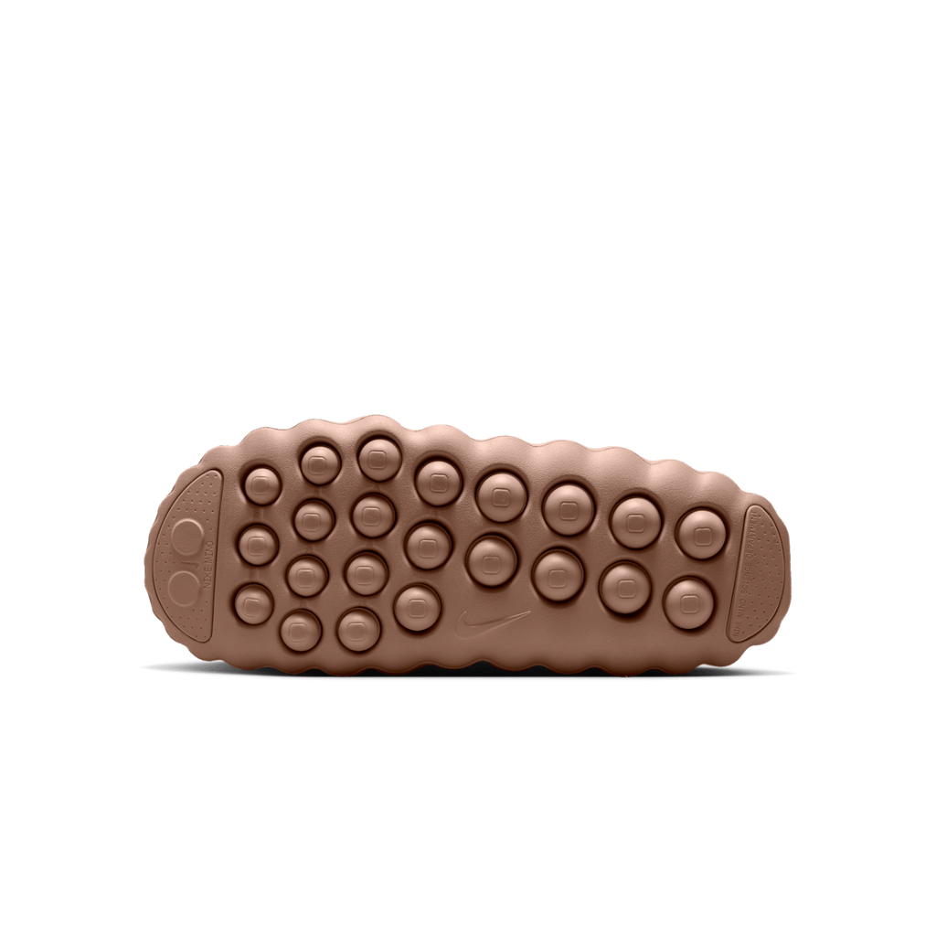 JeevzPlug Nike Mind 001 Slide in Sand Drift featuring a textured, molded rubber outsole with circular grip nodules.