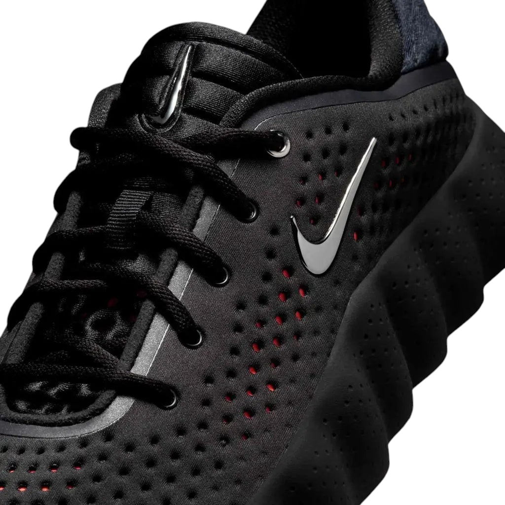 JeevzPlug Nike Mind 002 Black Chrome sneaker featuring a perforated upper, metallic swoosh, and sculpted midsole.