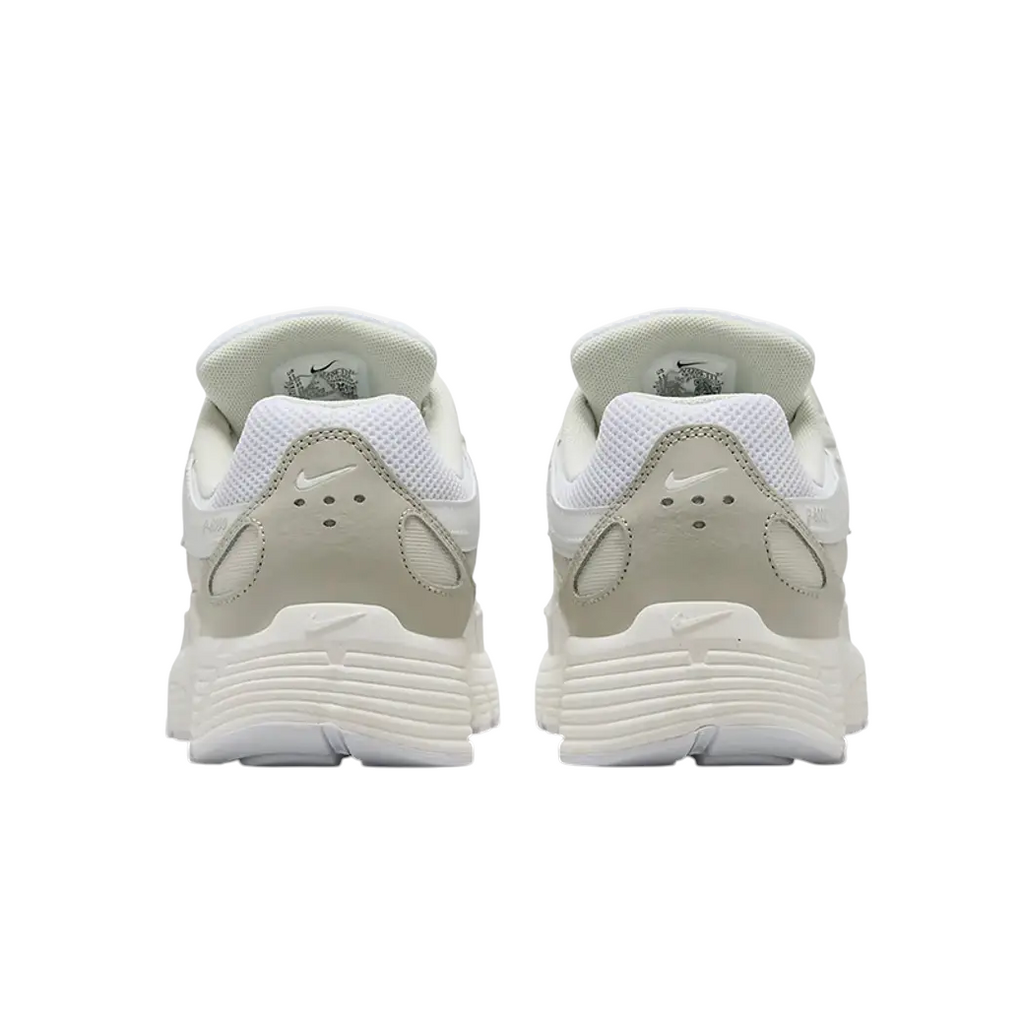 JeevzPlug Nike P-6000 sneakers in white, sail, and vast grey viewed from the back showing the heel and sole details.