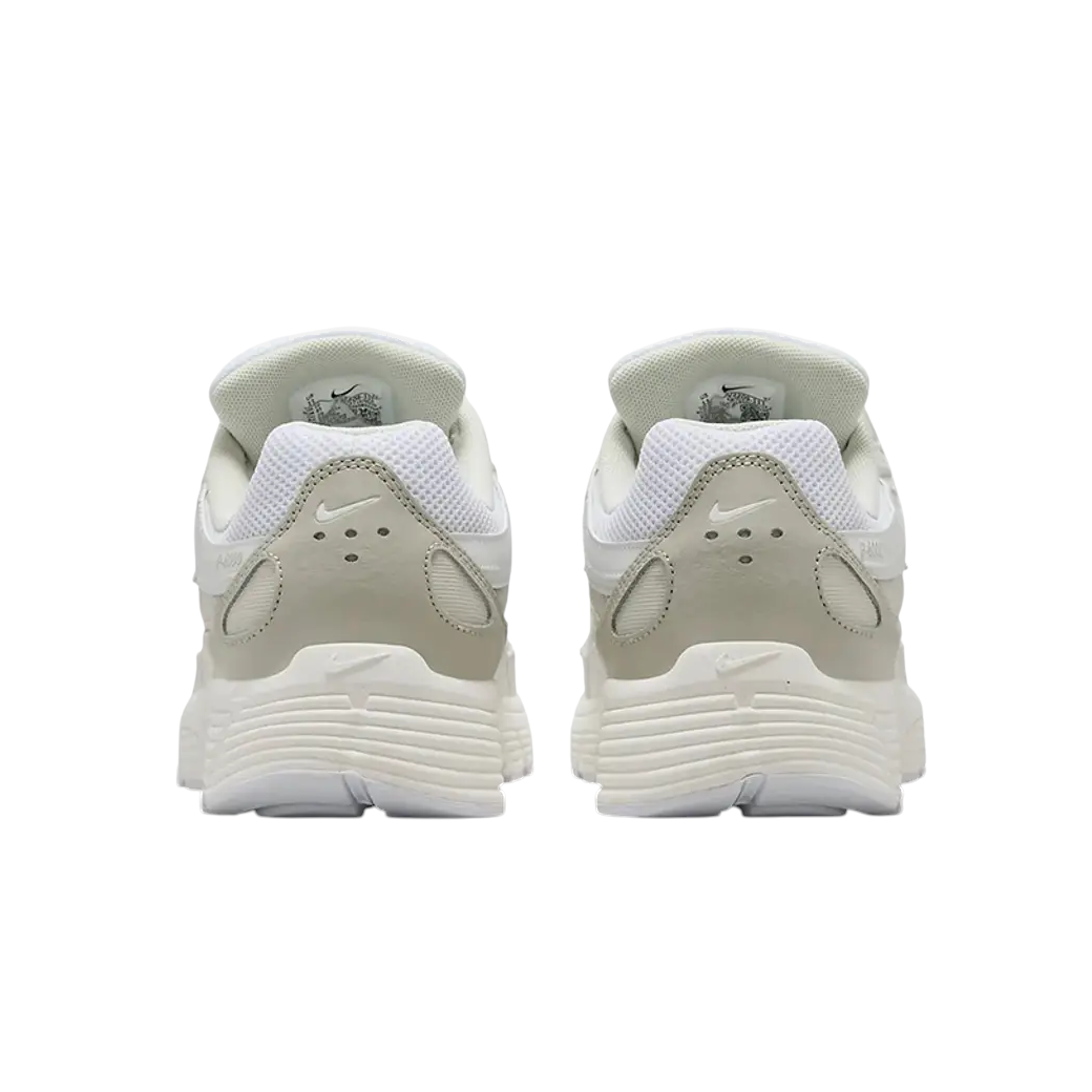 JeevzPlug Nike P-6000 sneakers in white, sail, and vast grey viewed from the back showing the heel and sole details.