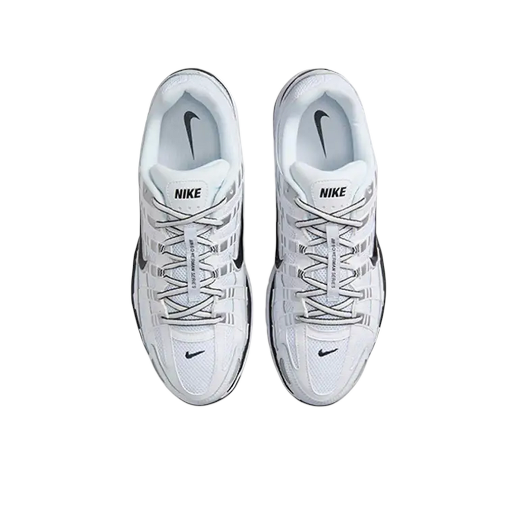 Top-down view of JeevzPlug Nike P-6000 sneakers in white, metallic silver, and black with mesh and leather overlays.