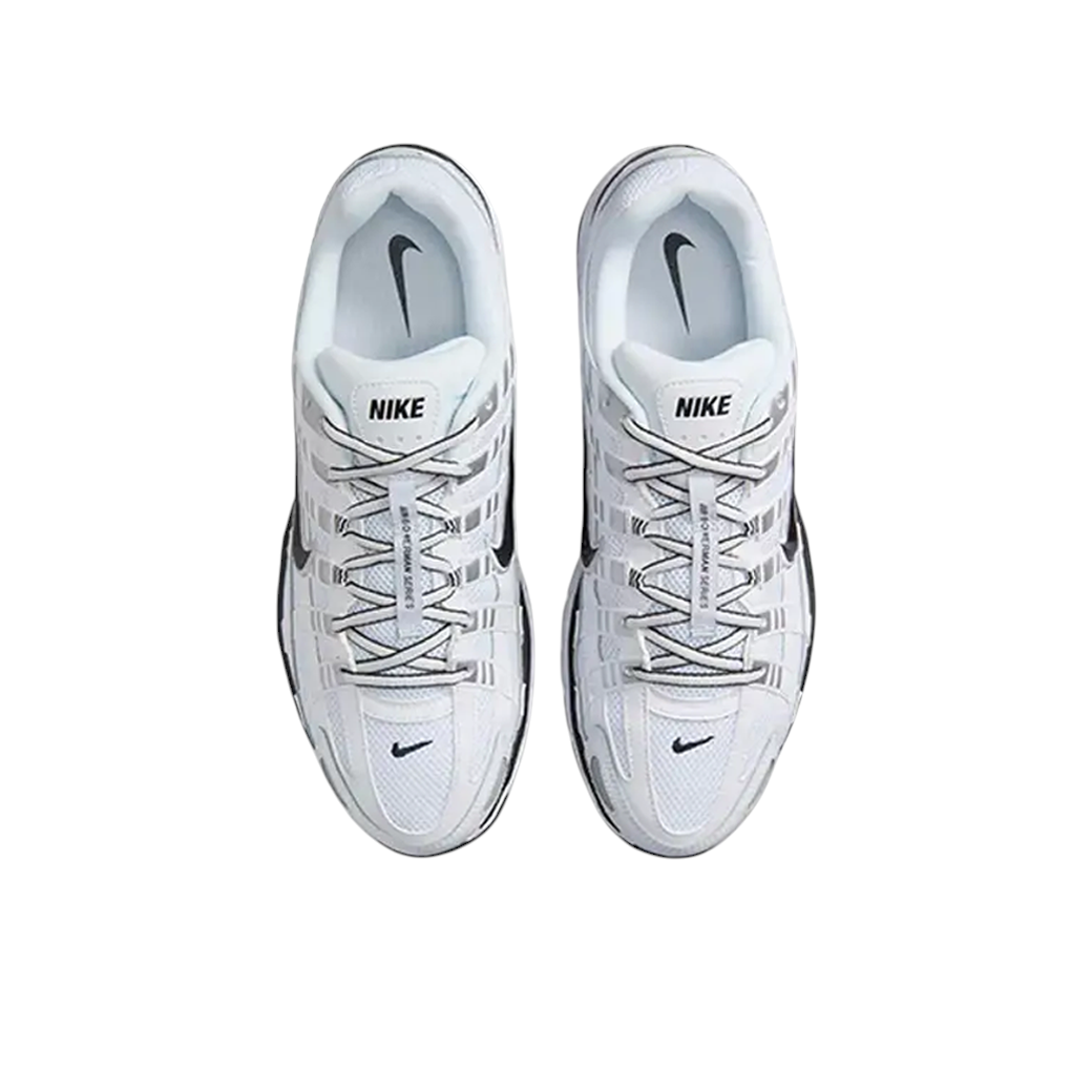 Top-down view of JeevzPlug Nike P-6000 sneakers in white, metallic silver, and black with mesh and leather overlays.